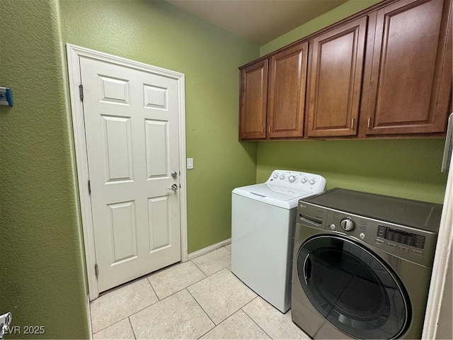 6277 Mustang Spring Ave, Las Vegas, NV 89139 - washroom with washing machine and dryer, cabinet space, light tile patterned floors, and a textured wall