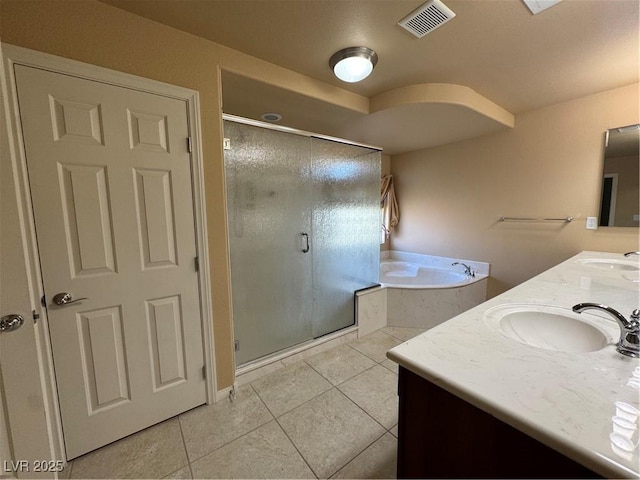 6277 Mustang Spring Ave, Las Vegas, NV 89139 - bathroom featuring double vanity, tile patterned flooring, a garden tub, and a stall shower