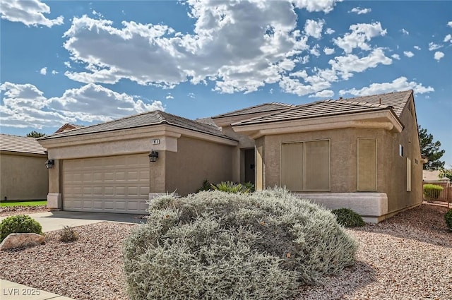 1816 Eagle Mesa Ave, Henderson, NV 89012 - prairie-style house featuring an attached garage, driveway, stucco siding, and a tile roof