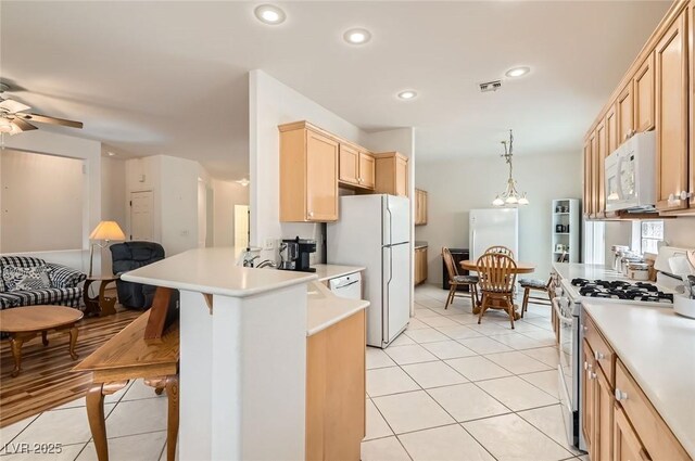 1816 Eagle Mesa Ave, Henderson, NV 89012 - kitchen with white appliances, light brown cabinets, open floor plan, light countertops, and a peninsula