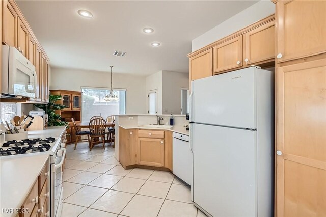 1816 Eagle Mesa Ave, Henderson, NV 89012 - kitchen featuring white appliances, a peninsula, light brown cabinets, light countertops, and light tile patterned flooring