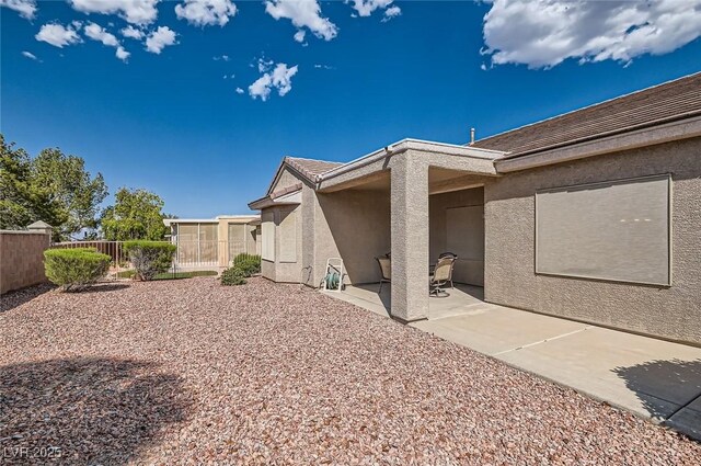 1816 Eagle Mesa Ave, Henderson, NV 89012 - view of home's exterior featuring stucco siding and a patio area