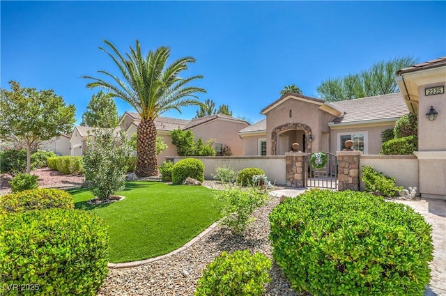 2225 Blackburn Hills Ave, Henderson, NV 89044 - mediterranean / spanish house featuring a fenced front yard, stucco siding, and a gate