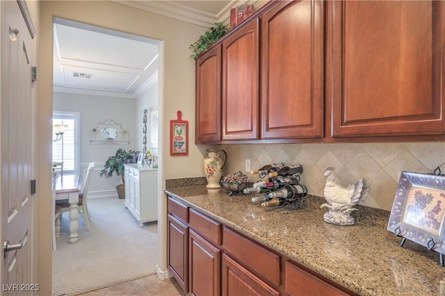 2225 Blackburn Hills Ave, Henderson, NV 89044 - kitchen with light carpet, light stone counters, ornamental molding, and tasteful backsplash