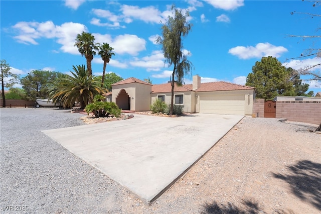 4530 W Shelbourne Ave, Las Vegas, NV 89139 - view of front facade featuring stucco siding, a garage, driveway, and a gate