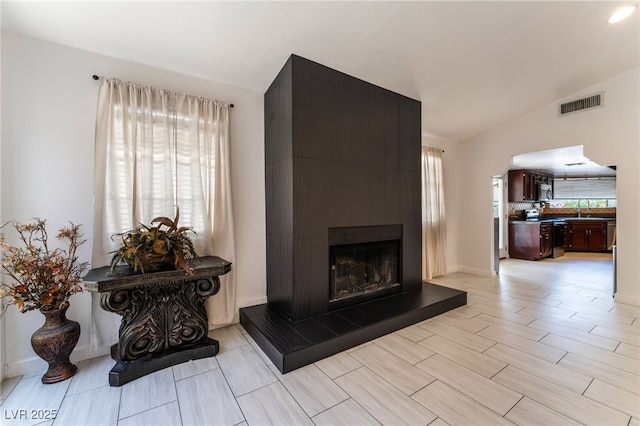 4530 W Shelbourne Ave, Las Vegas, NV 89139 - living area featuring a fireplace, lofted ceiling, and arched walkways