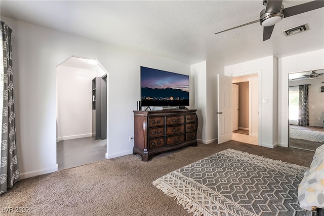 4530 W Shelbourne Ave, Las Vegas, NV 89139 - carpeted bedroom featuring arched walkways, ceiling fan, and a textured ceiling