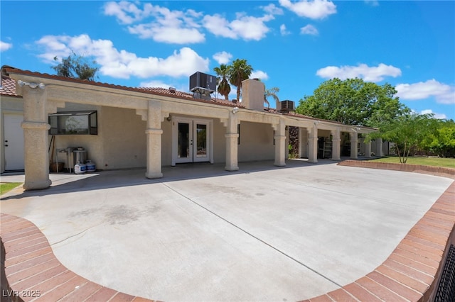 4530 W Shelbourne Ave, Las Vegas, NV 89139 - rear view of property featuring french doors, a patio area, stucco siding, and a chimney