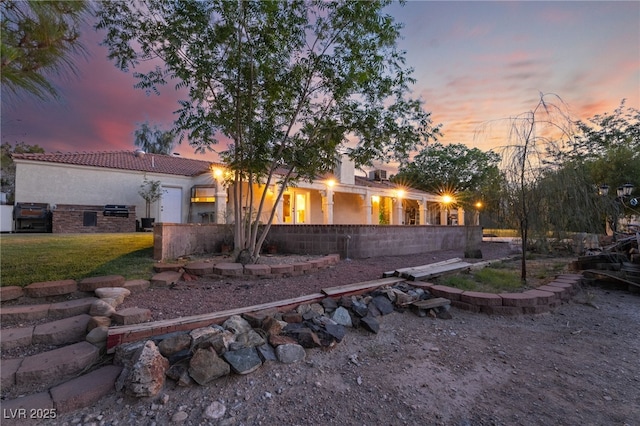 4530 W Shelbourne Ave, Las Vegas, NV 89139 - view of front facade with stucco siding, a tile roof, and a front yard
