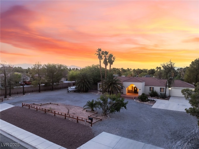 4530 W Shelbourne Ave, Las Vegas, NV 89139 - view of front of house featuring driveway, a tiled roof, and stucco siding
