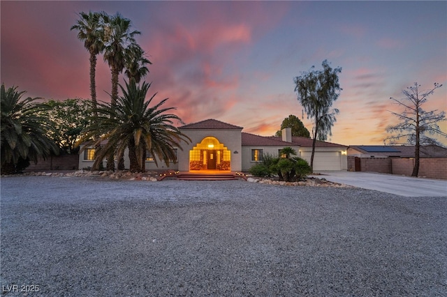 4530 W Shelbourne Ave, Las Vegas, NV 89139 - view of front of home featuring concrete driveway, a garage, a chimney, and stucco siding