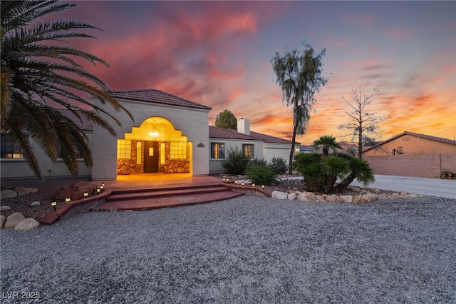 4530 W Shelbourne Ave, Las Vegas, NV 89139 - mediterranean / spanish home with concrete driveway, stucco siding, a chimney, and an attached garage