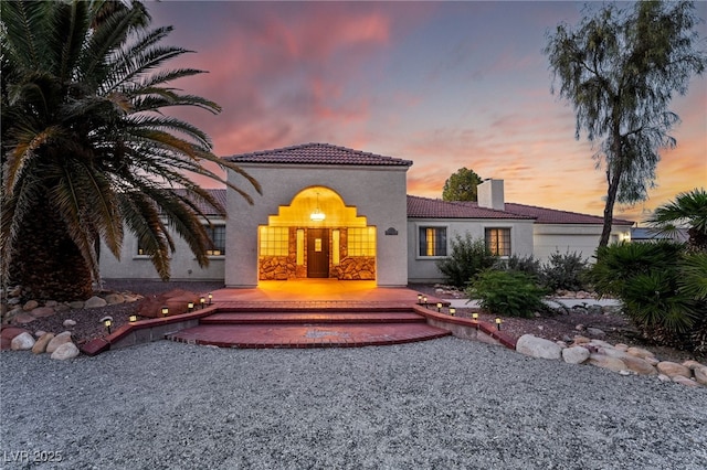 4530 W Shelbourne Ave, Las Vegas, NV 89139 - mediterranean / spanish home featuring a chimney, a tile roof, and stucco siding