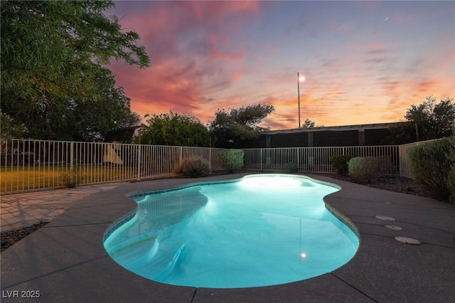 4530 W Shelbourne Ave, Las Vegas, NV 89139 - pool at dusk with a fenced backyard and a patio area