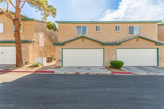 5249 Wave Dancer Ln, Las Vegas, NV 89118 - townhome / multi-family property featuring stucco siding and an attached garage