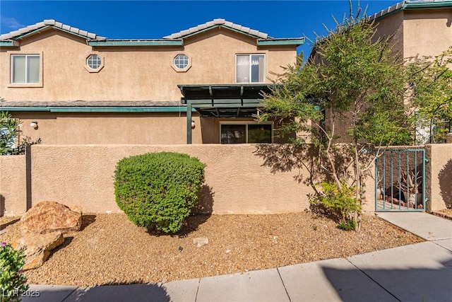 5249 Wave Dancer Ln, Las Vegas, NV 89118 - view of front facade featuring stucco siding, a gate, and a tiled roof