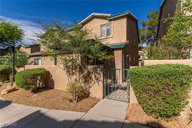 5249 Wave Dancer Ln, Las Vegas, NV 89118 - view of front of house with a fenced front yard, a gate, and stucco siding