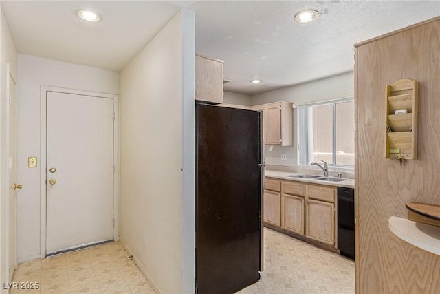 5249 Wave Dancer Ln, Las Vegas, NV 89118 - kitchen with freestanding refrigerator, light floors, black dishwasher, light countertops, and recessed lighting
