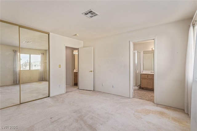 5249 Wave Dancer Ln, Las Vegas, NV 89118 - unfurnished bedroom featuring light colored carpet, a closet, and ensuite bath