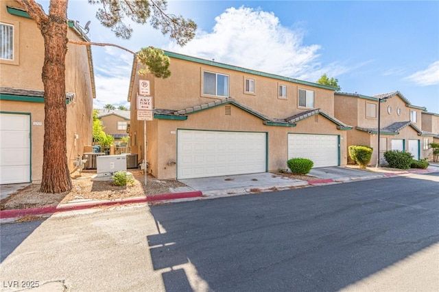 5249 Wave Dancer Ln, Las Vegas, NV 89118 - townhome / multi-family property featuring stucco siding and a garage