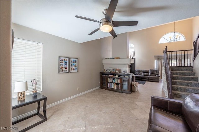 433 Jubilation Dr, Las Vegas, NV 89145 - living area featuring a chandelier, stairs, a ceiling fan, and light tile patterned floors