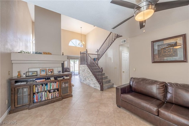 433 Jubilation Dr, Las Vegas, NV 89145 - living area with stairway, tile patterned flooring, a towering ceiling, ceiling fan, and a chandelier