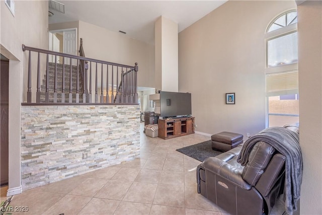 433 Jubilation Dr, Las Vegas, NV 89145 - living room with a towering ceiling, plenty of natural light, tile patterned flooring, and stairs