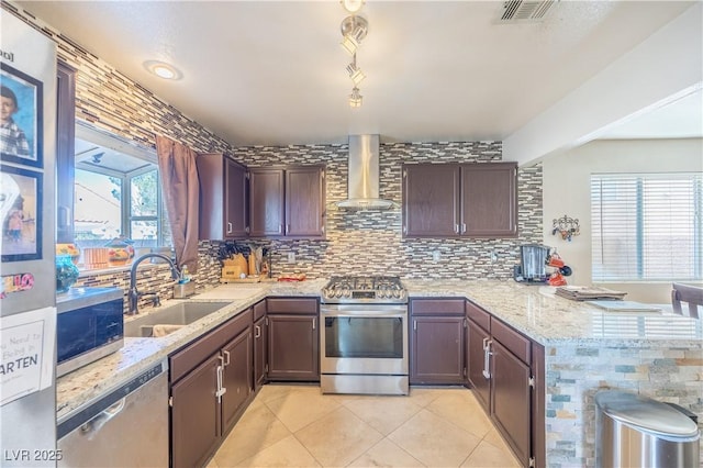 433 Jubilation Dr, Las Vegas, NV 89145 - kitchen featuring appliances with stainless steel finishes, wall chimney range hood, a peninsula, and decorative backsplash