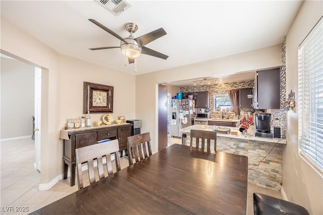 433 Jubilation Dr, Las Vegas, NV 89145 - dining room featuring ceiling fan, light tile patterned flooring, and a wood stove