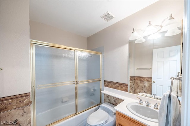 433 Jubilation Dr, Las Vegas, NV 89145 - bathroom with vanity, bath / shower combo with glass door, and wainscoting
