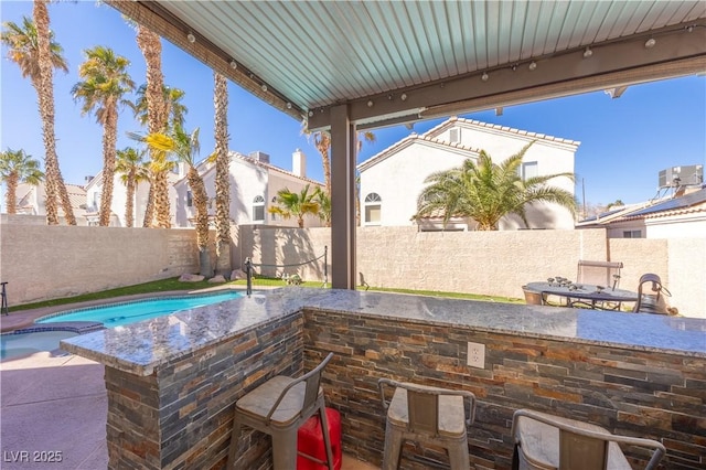 433 Jubilation Dr, Las Vegas, NV 89145 - fenced backyard with a patio area and a pool with connected hot tub