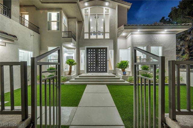 2058 Troon Dr, Henderson, NV 89074 - view of exterior entry featuring stucco siding and a yard
