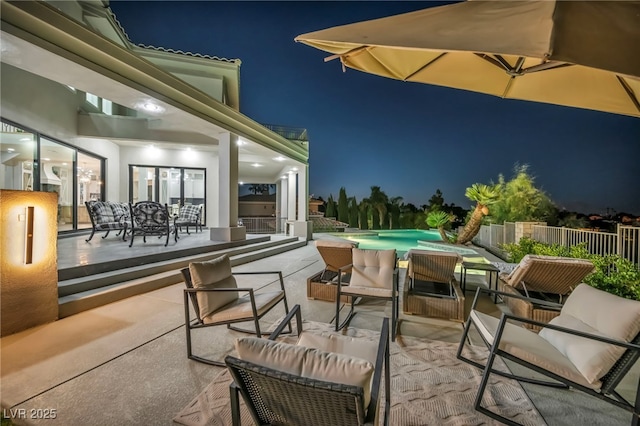 2058 Troon Dr, Henderson, NV 89074 - patio at night featuring a patio, an outdoor living space, and outdoor dining area