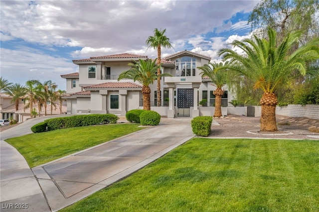 2058 Troon Dr, Henderson, NV 89074 - mediterranean / spanish home featuring stucco siding, a tiled roof, and a front lawn