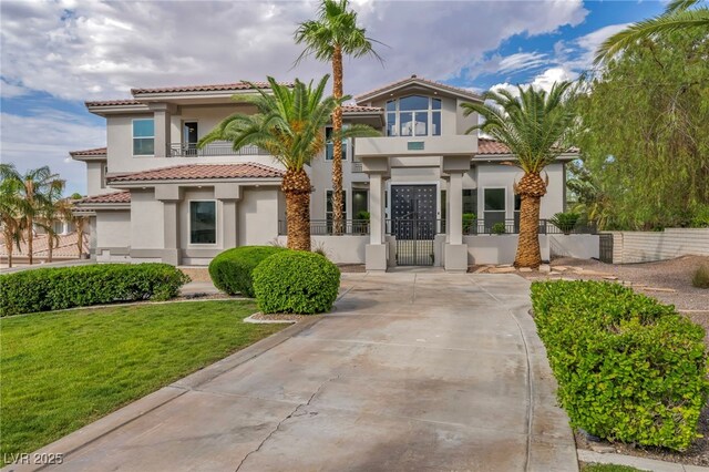 2058 Troon Dr, Henderson, NV 89074 - mediterranean / spanish-style home featuring a gate, stucco siding, and a tile roof