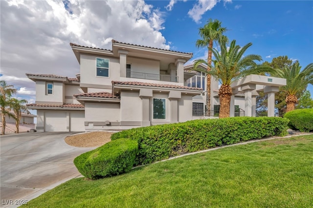 2058 Troon Dr, Henderson, NV 89074 - mediterranean / spanish home with an attached garage, concrete driveway, stucco siding, a front lawn, and a tile roof