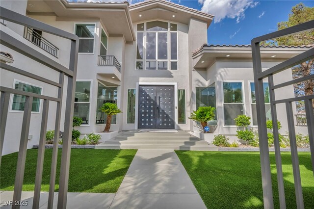 2058 Troon Dr, Henderson, NV 89074 - property entrance featuring stucco siding, a tiled roof, and a yard