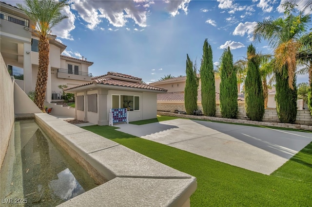 2058 Troon Dr, Henderson, NV 89074 - rear view of property featuring stucco siding, a patio area, and a tile roof