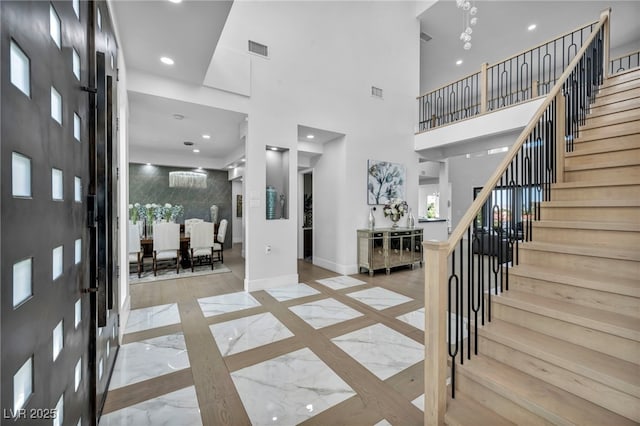 2058 Troon Dr, Henderson, NV 89074 - foyer entrance with marble tiled floors, inlaid floor details, stairs, recessed lighting, and a high ceiling