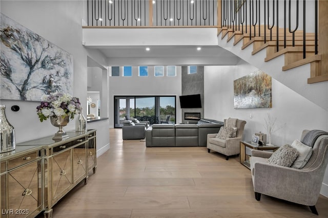 2058 Troon Dr, Henderson, NV 89074 - living room featuring a towering ceiling, wood finished floors, and stairs