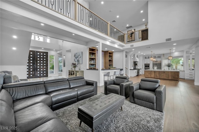 2058 Troon Dr, Henderson, NV 89074 - living area with a high ceiling, light wood-style flooring, plenty of natural light, and recessed lighting