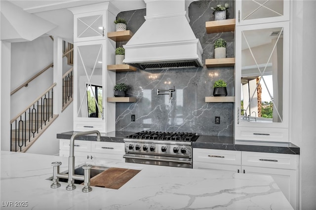 2058 Troon Dr, Henderson, NV 89074 - kitchen with premium range hood, open shelves, high end range, and white cabinets