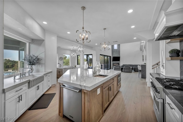 2058 Troon Dr, Henderson, NV 89074 - kitchen with a chandelier, appliances with stainless steel finishes, open floor plan, recessed lighting, and a center island with sink