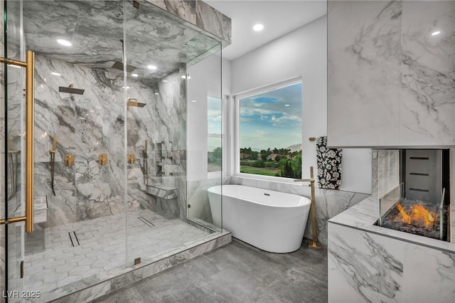 2058 Troon Dr, Henderson, NV 89074 - bathroom with a soaking tub, marble tiled floors, a marble finish shower, and recessed lighting