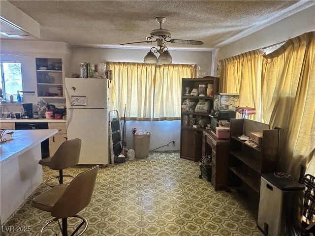 3505 W Bonanza Rd, Las Vegas, NV 89107 - kitchen with freestanding refrigerator, ceiling fan, a textured ceiling, open shelves, and light countertops