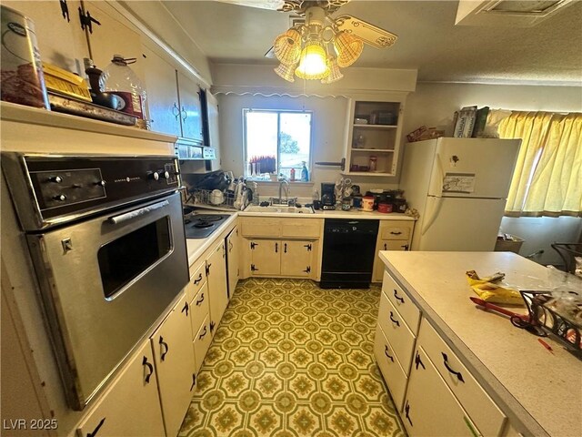 3505 W Bonanza Rd, Las Vegas, NV 89107 - kitchen with black dishwasher, freestanding refrigerator, wall oven, light countertops, and electric stovetop