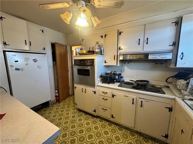 3505 W Bonanza Rd, Las Vegas, NV 89107 - kitchen featuring stainless steel oven, freestanding refrigerator, light countertops, electric stovetop, and under cabinet range hood