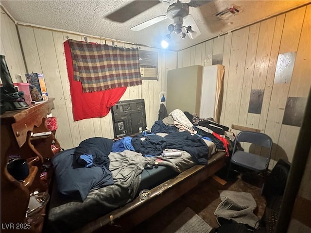 3505 W Bonanza Rd, Las Vegas, NV 89107 - bedroom with wood walls, ceiling fan, and a textured ceiling