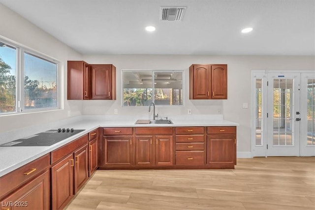 2868 Vista Del Sol Ave, Las Vegas, NV 89120 - kitchen featuring black electric cooktop, light countertops, light wood-style flooring, recessed lighting, and french doors