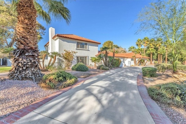 2868 Vista Del Sol Ave, Las Vegas, NV 89120 - mediterranean / spanish-style home featuring a tiled roof, stucco siding, and a chimney